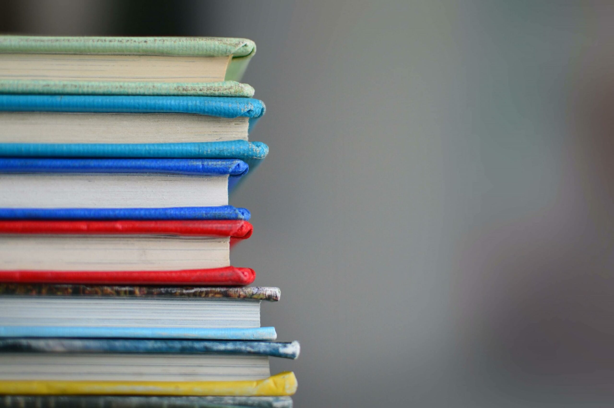 Pile of different coloured books.