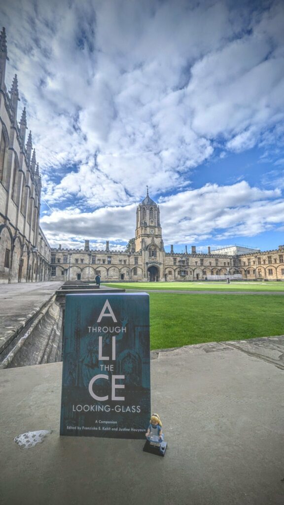 An image of the book 'Alice Through the Looking Glass' with picturesque Oxford in the background. As provided by Dr. Franziska Kohlt.
